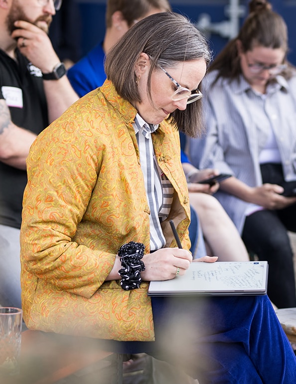 Photo of Ann taking notes.